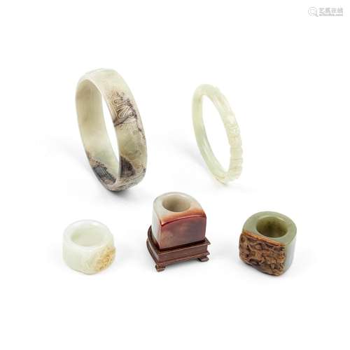 A GROUP OF VARIOUSLY JADE, JADEITE, AND HARDSTONE BANGLES AN...