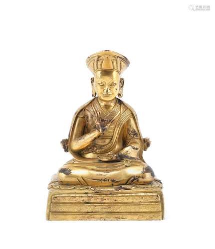 A GILT-BRONZE COPPER-ALLOY FIGURE OF A LAMA