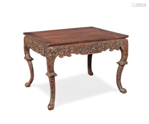 A CARVED HARDWOOD TABLE