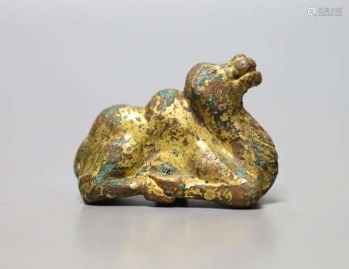 A Chinese gilt bronze figure of a kneeling camel, Han or lat...