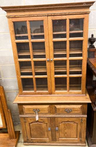 A reproduction oak bookcase cupboard, width 97cm, depth 43cm...