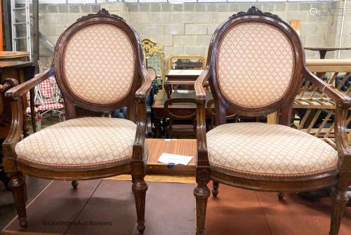 A pair of 19th century French walnut upholstered elbow chair...