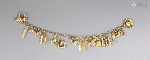 A 9ct oval link charm bracelet, hung with assorted mainly 9c...