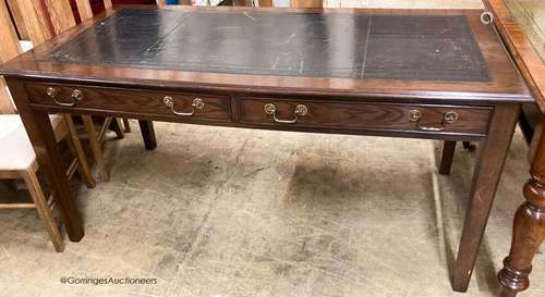 A reproduction oak two drawer writing table, W.160cm D.80cm ...