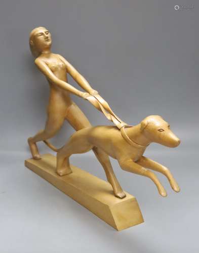 An Art Deco style light elm carving of a woman and dog on le...