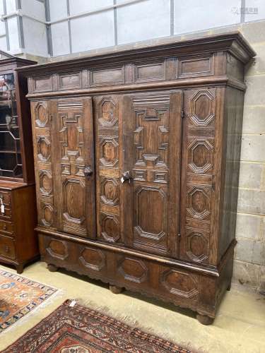 A 17th century and later panelled oak cupboard, length 194cm...