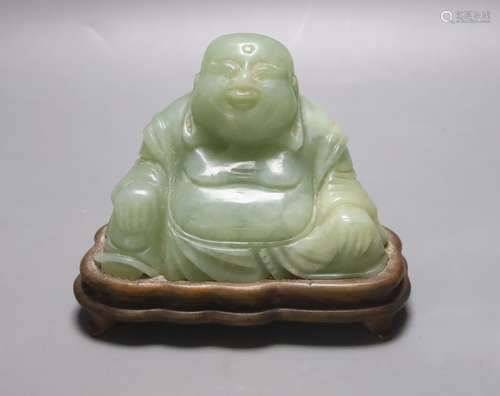 A Chinese carved bowenite jade figure of a seated Budai, H 9...