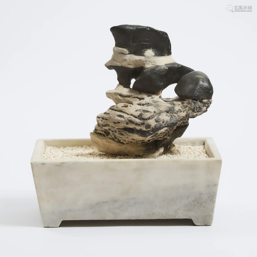 A Chinese Lingbi Scholar's Rock in a Marble Jardinière,