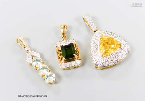 Three assorted modern 18ct gold and gem set pendants, includ...