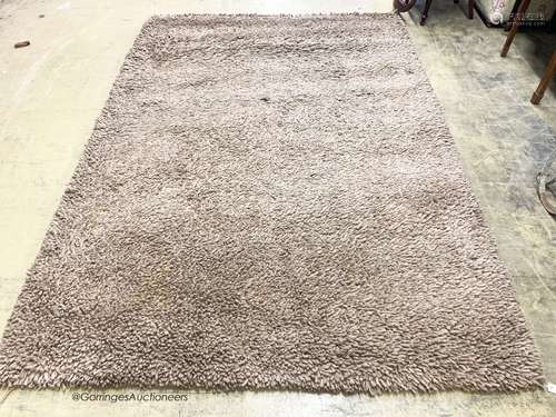 A contemporary brown shag pile carpet, 300 x 200cm