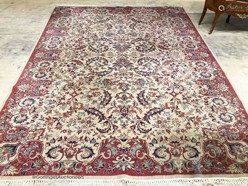 A Persian style ivory ground carpet, 380 x 280cm