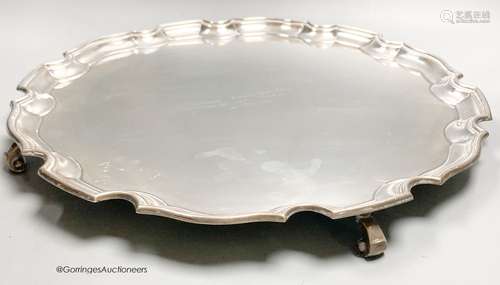 A circular silver salver with Chippendale border, diameter 4...