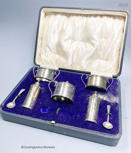 A cased George V silver five piece condiment set and two spo...