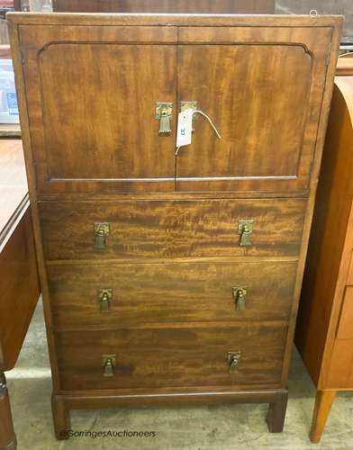 A 1920's mahogany three drawer side cabinet, stamped Waring ...