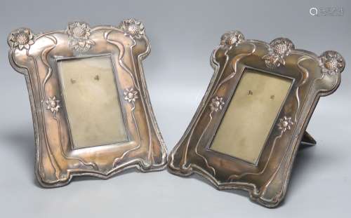 A pair of Art Nouveau embossed copper photograph frames, hei...