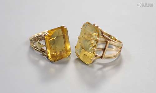 Two yellow metal and citrine set dress rings, one faintly ma...