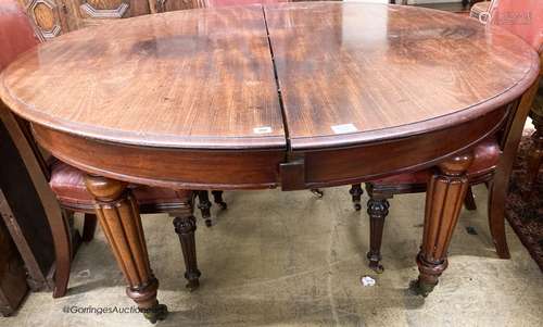 A Victorian mahogany extending dining table with four leaves...