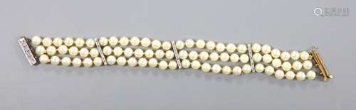 A triple strand cultured pearl bracelet, with yellow metal a...