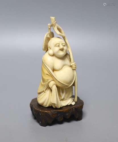 An early 20th century Japanese carved ivory okimono of Hotei...