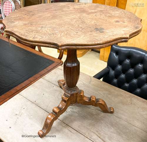 An early 20th century circular oak tripod table, W.67cm H.69...