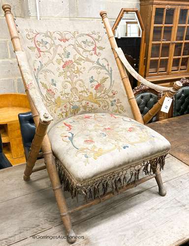 A Victorian faux bamboo folding chair with tapestry upholste...