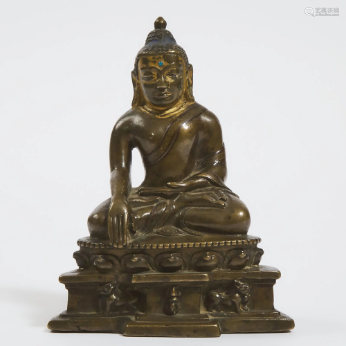 A Silver and Copper inlaid Bronze Buddha, Tibet, 14th