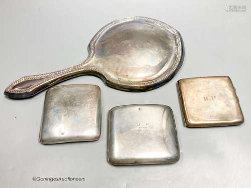 A George V silver mounted hand mirror and three silver cigar...