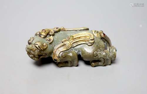 A Chinese celadon jade and gilt metal mounted figure of a Pi...