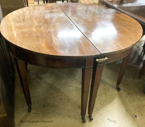 A pair of George III mahogany D shaped table sections, each ...