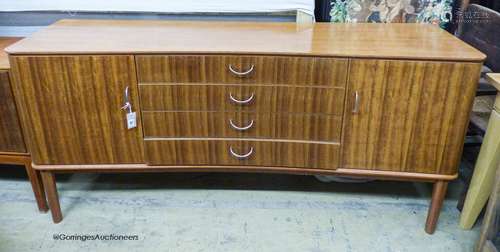 A Gordon Russell Ltd teak and Indian Laurel concave sideboar...