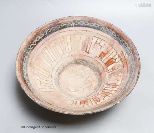 An Islamic bowl with kufic script, diameter 24cm