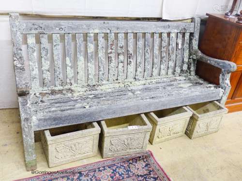 A weathered teak garden bench, length 182cm, depth 68cm, hei...