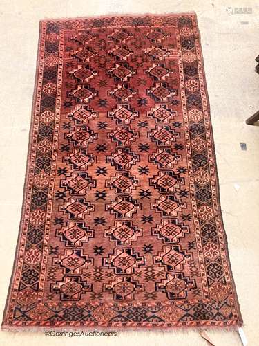 A Bokhara burgundy ground rug, 190 x 105cm