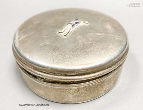 A white metal circular box and hinged cover, with enamelled ...