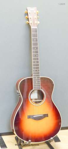 A Yamaha LSTA Tran Acoustic guitar, sunburst with Yamaha sof...