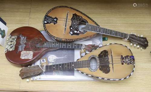 Three Neapolitan mandolins with inlaid mother of pearl decor...