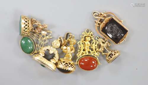 Seven assorted modern yellow metal overlaid and gem set fob ...