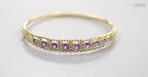 A modern 9ct gold and graduated nine stone amethyst set brac...