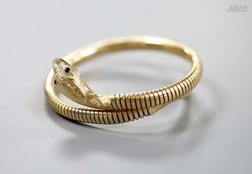 A mid 20th century 9ct gold coiled serpent bracelet, with ge...