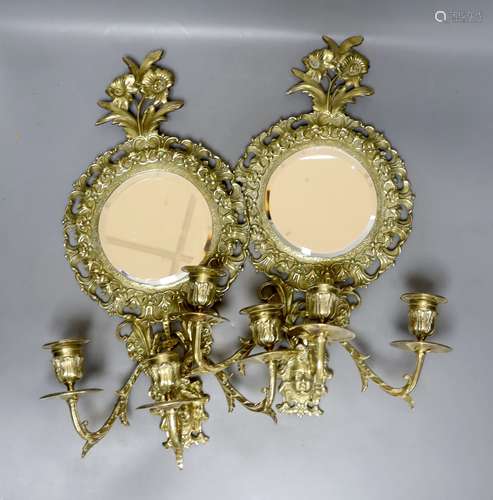 A pair of late 19th century French cast brass three sconce g...