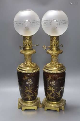 A pair of 19th century French ormolu and enamelled oil lamps...