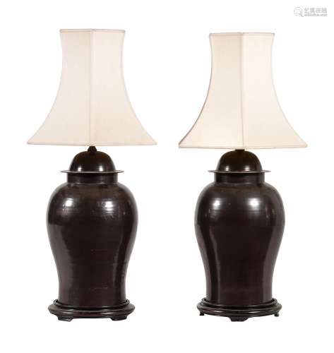 A pair of Chinese bronze lamps
