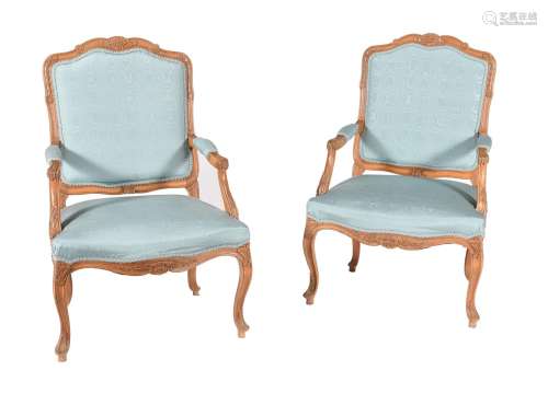 A pair of carved beech and blue upholstered fauteuil in Loui...