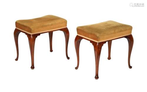 A pair of mahogany and upholstered stools