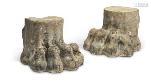 A pair of Regency carved stone lion paw supports