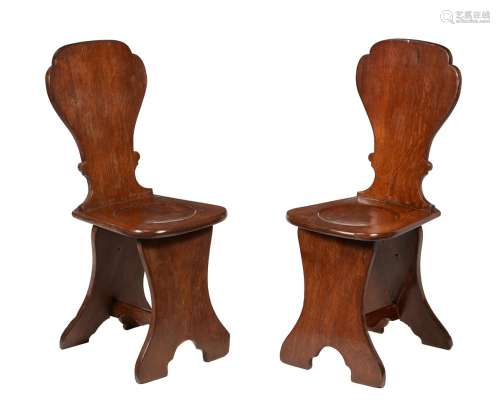A pair of George II oak sgabello hall chairs