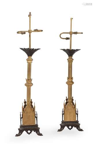 A pair of gilt and patinated metal table lamps in Regency Go...