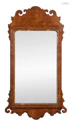 A George II walnut and parcel gilt composition wall mirror