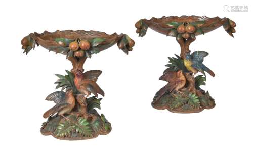 A pair of carved wood and polychrome decorated centrepieces ...