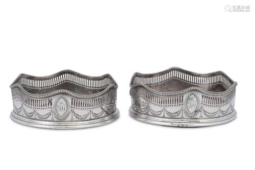 A pair of George III sterling silver wine coasters, London 1...